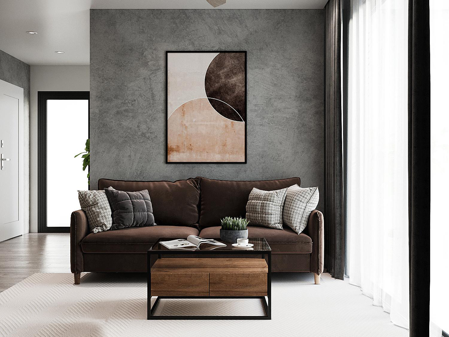 Ghế sofa tông màu nâu trầm kết hợp ăn ý với bàn trà gỗ - kim loại và tranh treo tường nghệ thuật. Tất cả đều nổi bật ở mức vừa phải trên phông nền màu xám bê tông chủ đạo.