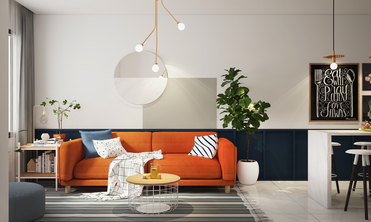 Gia chủ trang trí phòng khách theo phong cách hiện đại tối giản với điểm nhấn ấm áp là ghế sofa màu cam kết hợp cùng thảm trải kẻ sọc màu xám, cây xanh đối xứng hai bên.