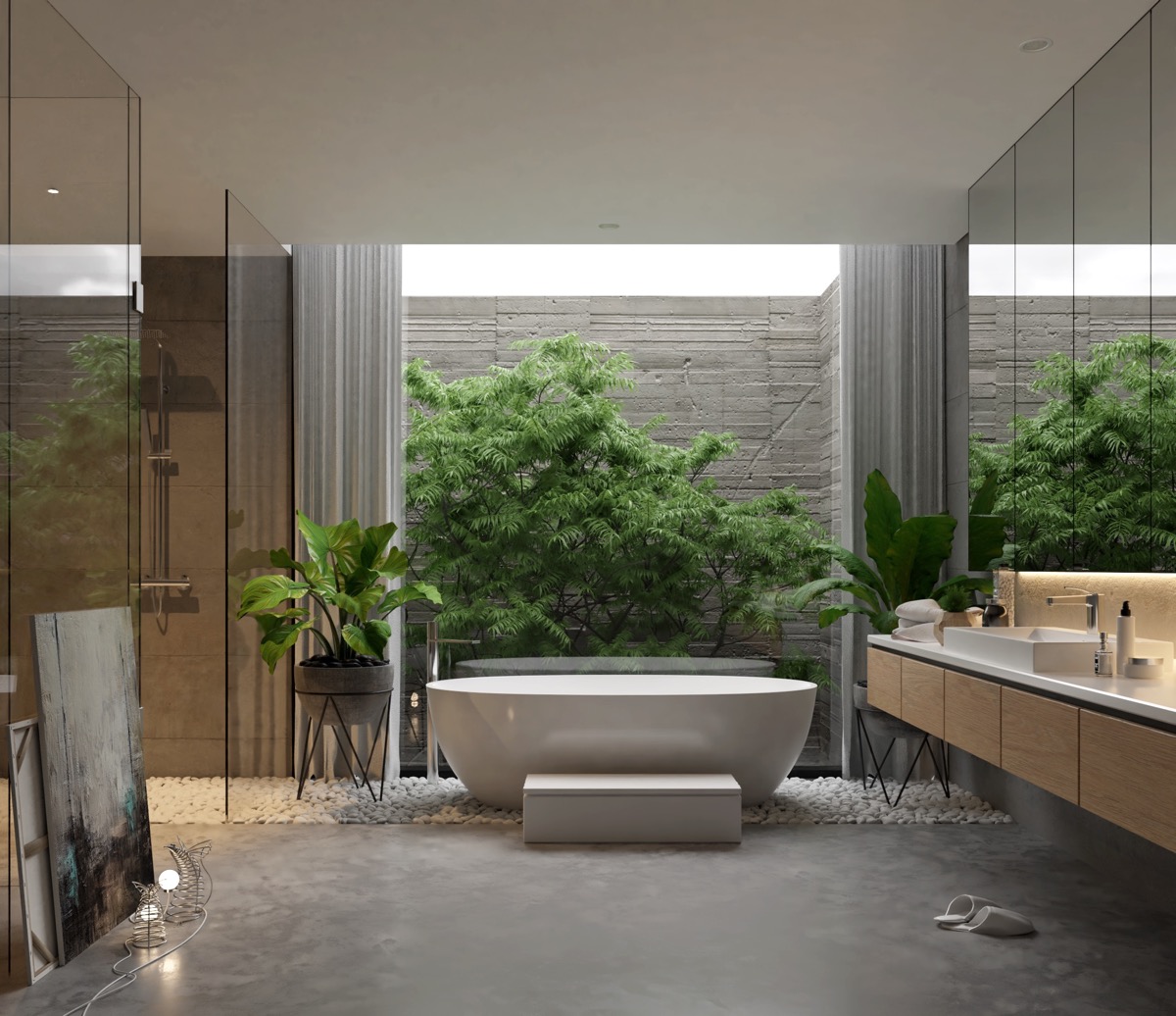 Phòng tắm được thiết kế theo phong cách mở phóng khoáng, kết nối trực tiếp với giếng trời thoáng sáng và vườn mini ngay cạnh.
