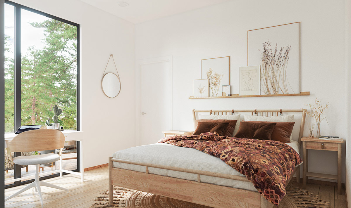 Bên trong phòng ngủ, một chiếc giường bằng gỗ phong cách Scandinavian được trang trí với sắc cam đậm và màu xám in họa tiết Boho. Một chiếc gương tròn đơn giản tô điểm cho bức tường bên cạnh cửa sổ. 