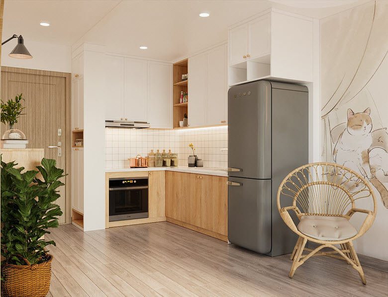 Gian bếp nhỏ chữ L tiện nghi, ấm cúng. Hệ tủ bếp liền tường màu trắng cánh phẳng tạo cảm giác thoáng rộng hơn cho căn hộ về mặt thị giác.