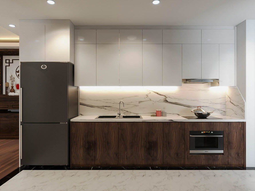 Phòng bếp với thiết kế hiện đại, tủ cánh phẳng gọn thoáng. Cửa tủ bếp dưới tông màu gỗ óc chó tạo cảm giác ấm cúng hơn.