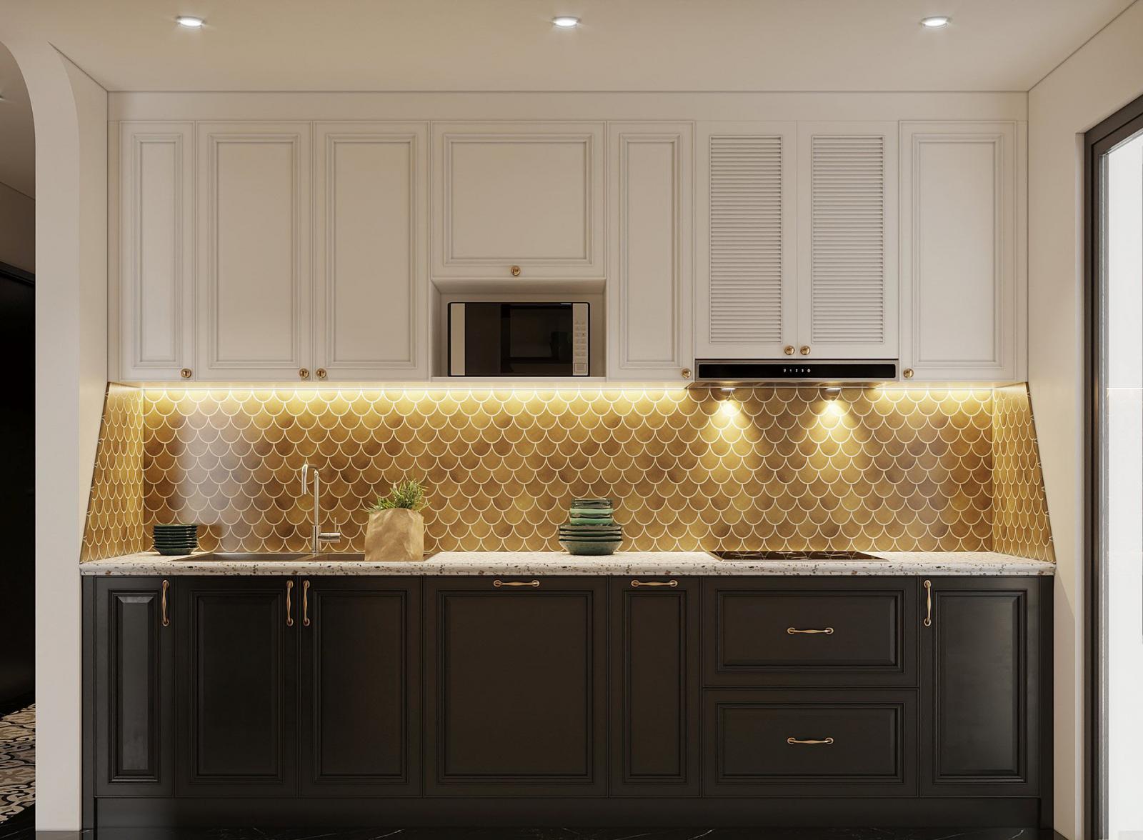 Tường chắn bếp ốp gạch vảy cá màu vàng đồng nổi bật và hài hòa với hệ tủ bếp trên màu trắng, tủ bếp dưới màu đen tuyền cá tính.