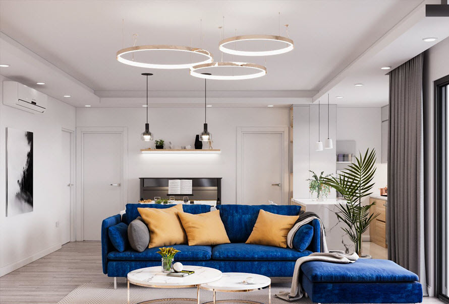 Bộ ghế sofa màu xanh coban và những chiếc gối tựa màu vàng nắng khiến phòng khách căn hộ như bừng sáng và tràn đầy sức sống.