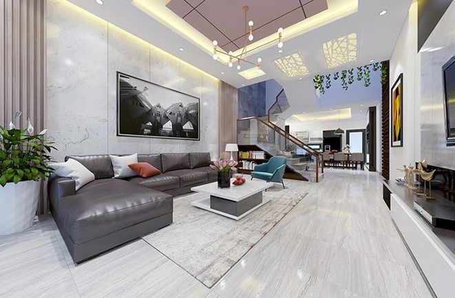 Không gian phòng khách nhà ống được thiết kế theo phong cách mở rộng thoáng, bài trí nội thất hiện đại với ghế sofa da tạo điểm nhấn sáng trọng.