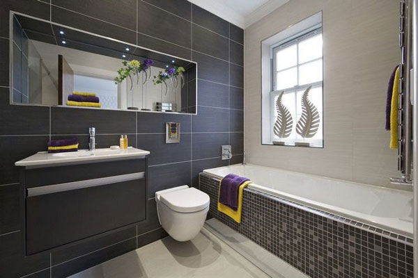 Thiết kế phòng tắm - vệ sinh tiện nghi, sang trọng cho nhà ống 2 tầng. Tường gạch ốp màu xanh than tạo cảm giác sang chảnh hơn cho căn phòng.