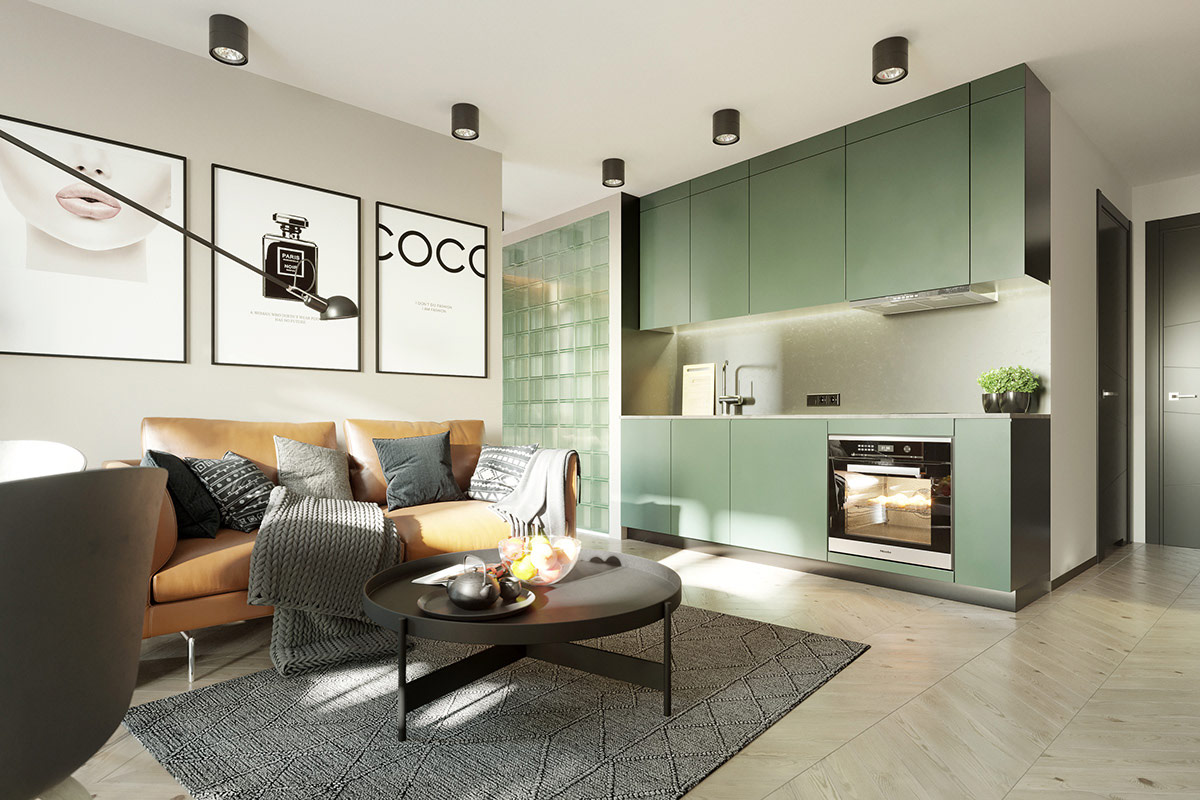 Ghế sofa màu nâu tạo sự tương phản ấm áp với thiết kế nhà bếp màu xanh lá cây ngay cạnh.