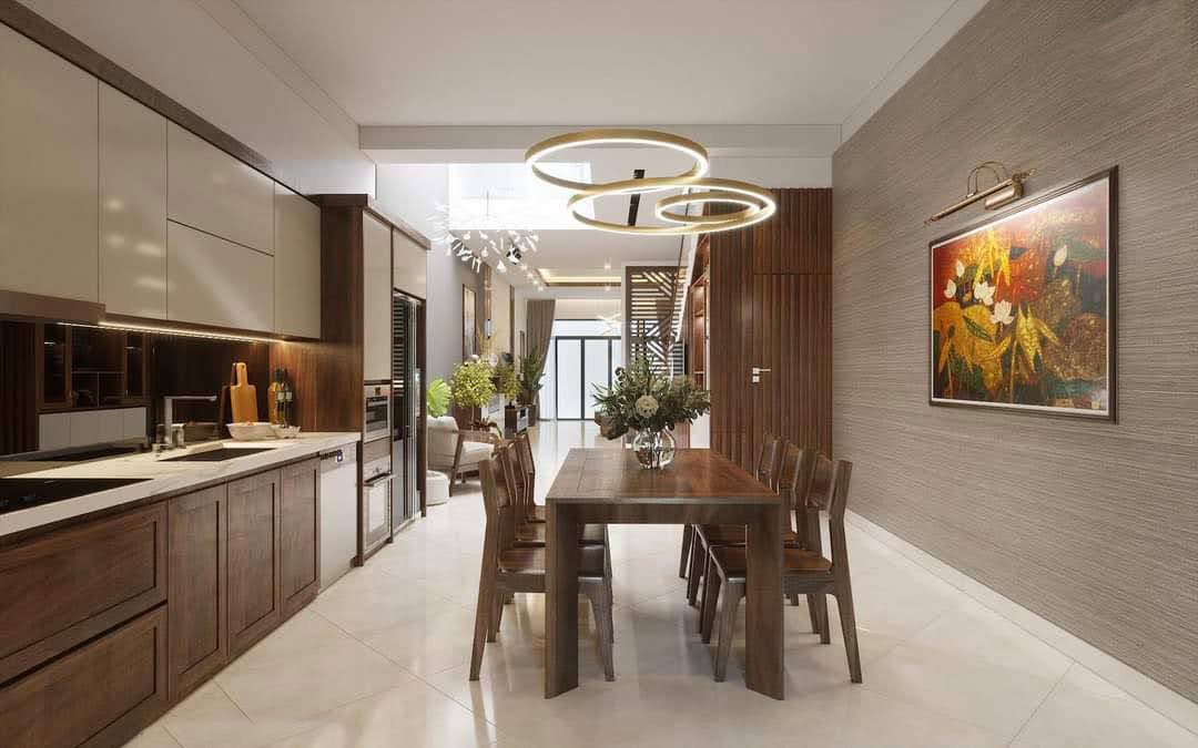 Thiết kế phòng ăn và bếp phong cách hiện đại với màu vân gỗ sang trọng, ấm cúng. Bếp và bàn ăn có sự đồng bộ về màu sắc đem lại cảm giác hài hòa, thống nhất giúp không gian trở nên ấn tượng hơn.