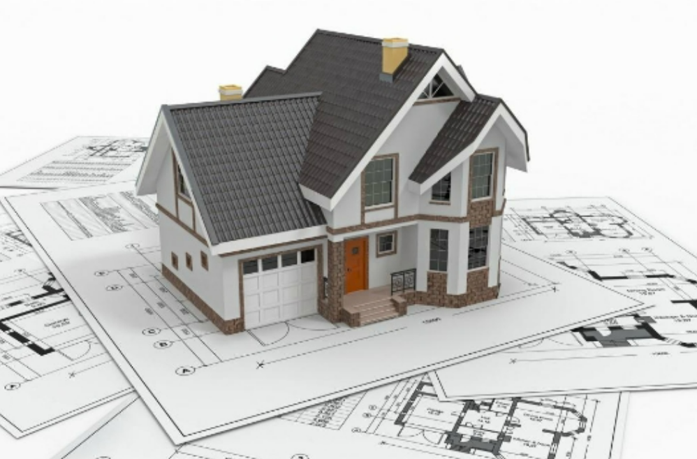 mô hình ngôi nhà đặt trên bản thiết kế nhà